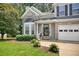 Charming two-story home featuring a manicured lawn, brick accents, and attached two-car garage in a suburban neighborhood at 4000 Mcpherson Drive Dr, Acworth, GA 30101
