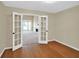 Bright living room with bamboo floors and French doors showcasing natural light and an open floor plan, for relaxing at 4000 Mcpherson Drive Dr, Acworth, GA 30101
