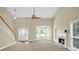 Open concept living room featuring a fireplace, large windows, and a staircase leading to the upper level at 4000 Mcpherson Drive Dr, Acworth, GA 30101