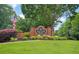 Inviting entrance to McEver Park with a brick sign surrounded by lush greenery and an American flag at 4000 Mcpherson Drive Dr, Acworth, GA 30101