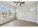 Well-lit bedroom featuring three windows with views of the neighborhood at 4480 Beechnut Cir, Cumming, GA 30028