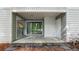 Covered balcony with sliding door access, concrete floor, and view of wooded area at 47 Arbor End, Smyrna, GA 30080