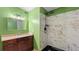 Bathroom featuring a modern vanity with granite countertop and a marble-tiled shower with a black showerhead at 47 Arbor End, Smyrna, GA 30080