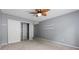 Neutral bedroom with carpeted floor, ceiling fan, closet, large window with blinds, and built-in shelves at 47 Arbor End, Smyrna, GA 30080