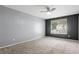 Spacious bedroom with large window, grey walls, and carpeted floor at 47 Arbor End, Smyrna, GA 30080