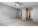 Neutral bedroom with carpeted floor, grey walls, ceiling fan, and access to closet and bathroom at 47 Arbor End, Smyrna, GA 30080