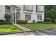 Inviting exterior of condo featuring a well-kept lawn, walkway, and manicured landscaping at 47 Arbor End, Smyrna, GA 30080