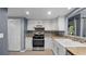 Modern kitchen with stainless steel appliances, new floors, and a beautiful stone countertop at 47 Arbor End, Smyrna, GA 30080