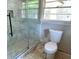 Bright bathroom showcasing a modern glass-enclosed shower and a toilet at 1968 Rosewood Rd, Decatur, GA 30032