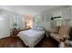 Comfortable bedroom with shuttered windows, hardwood floors, and a cozy chair for relaxation at 2260 Peachtree Nw Rd # B4, Atlanta, GA 30309