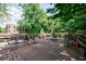 Spacious outdoor deck shaded by trees, furnished with patio furniture for comfortable outdoor living at 2260 Peachtree Nw Rd # B4, Atlanta, GA 30309