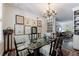 Elegant dining room with glass table, ornate chandelier, and built-in shelving for sophisticated living at 2260 Peachtree Nw Rd # B4, Atlanta, GA 30309