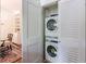 Convenient laundry area with stacked washer and dryer units neatly tucked behind louvered doors at 2260 Peachtree Nw Rd # B4, Atlanta, GA 30309