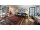 Spacious living room featuring hardwood floors, a large oriental rug, built-in bookshelves, and neutral paint at 2260 Peachtree Nw Rd # B4, Atlanta, GA 30309