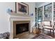 Cozy living room features a fireplace with mantle, hardwood floors, and built-in bookshelves at 2260 Peachtree Nw Rd # B4, Atlanta, GA 30309