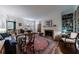 Bright living room features hardwood floors, a fireplace, built-in bookshelves, and access to a sunroom at 2260 Peachtree Nw Rd # B4, Atlanta, GA 30309