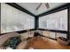 Bright sunroom featuring a cozy seating area, natural light, and views of the surrounding neighborhood at 2260 Peachtree Nw Rd # B4, Atlanta, GA 30309