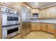 Close up of kitchen stainless steel appliances and wood cabinets at 2883 Thurleston Ln, Duluth, GA 30097