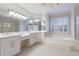 A spacious Primary bathroom features a soaking tub, dual sinks, and ample counter space at 2883 Thurleston Ln, Duluth, GA 30097