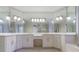 Spacious bathroom with double sinks, marble countertops, an oversized mirror, and tile floors at 2883 Thurleston Ln, Duluth, GA 30097