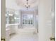 A full bathroom features a soaking tub, vanity with mirrors, and tile flooring at 2883 Thurleston Ln, Duluth, GA 30097