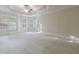 Large bedroom featuring neutral carpet, ceiling fan, tray ceiling, and large bright windows at 2883 Thurleston Ln, Duluth, GA 30097