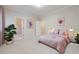 Cozy bedroom showcasing soft pink bedding, neutral walls and minimalist decor at 2883 Thurleston Ln, Duluth, GA 30097