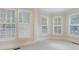 Cozy bedroom with carpeted floor and natural lighting from the many large windows around the room at 2883 Thurleston Ln, Duluth, GA 30097