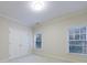 Bright bedroom featuring neutral paint, plush carpet, natural light and double door closet at 2883 Thurleston Ln, Duluth, GA 30097