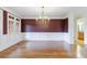 Formal dining room with elegant chandelier, white wainscoting, large windows, and hardwood flooring at 2883 Thurleston Ln, Duluth, GA 30097