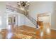 Open floor plan with an iron railed staircase, hardwood floors, and large windows at 2883 Thurleston Ln, Duluth, GA 30097