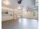 Spacious garage with ample storage shelves, windows, and overhead lighting at 2883 Thurleston Ln, Duluth, GA 30097