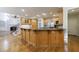 Spacious kitchen with a large island, wood cabinetry, stainless appliances, and hardwood flooring at 2883 Thurleston Ln, Duluth, GA 30097