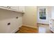 Well-equipped laundry room with window, hardwood floor, and washer/dryer hookups at 2883 Thurleston Ln, Duluth, GA 30097