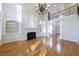 Bright living room with fireplace, built-in shelving, hardwood floors and large windows at 2883 Thurleston Ln, Duluth, GA 30097