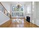 Bright living room with a fireplace, large windows, built-in shelves, and hardwood floors at 2883 Thurleston Ln, Duluth, GA 30097