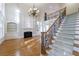 Bright living room with large windows, fireplace, hardwood floors, and staircase at 2883 Thurleston Ln, Duluth, GA 30097