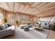 Bright, open living room with wood ceiling and floors and multiple windows at 2883 Thurleston Ln, Duluth, GA 30097