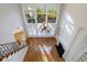 Bright living room with two-story windows, fireplace, hardwood floors and iron stairway railing at 2883 Thurleston Ln, Duluth, GA 30097