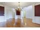 Spacious living room featuring hardwood floors, wainscoting, and white pillars at 2883 Thurleston Ln, Duluth, GA 30097