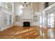 Elegant living room with hardwood floors, fireplace, built-in bookshelves, and bright natural light at 2883 Thurleston Ln, Duluth, GA 30097