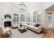 Living room with fireplace, hardwood floors, large windows, and comfortable sectional seating at 2883 Thurleston Ln, Duluth, GA 30097