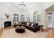 Inviting living room featuring a cozy fireplace, elegant chandelier and many windows at 2883 Thurleston Ln, Duluth, GA 30097