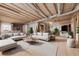 Open living room featuring exposed beams, hardwood floor, and large windows at 2883 Thurleston Ln, Duluth, GA 30097