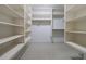 A walk-in closet featuring an abundance of shelving, multiple clothing rods, and neutral decor at 2883 Thurleston Ln, Duluth, GA 30097
