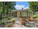 Landscaped backyard with a covered carport and deck with wooded views at 3390 Kenland Se Rd, Smyrna, GA 30082