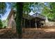 Exterior back view of the house with a deck overlooking a wooded area at 3390 Kenland Se Rd, Smyrna, GA 30082