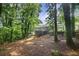 Scenic backyard view featuring a large deck and lush greenery at 3390 Kenland Se Rd, Smyrna, GA 30082
