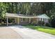 Charming brick home with a spacious carport and well-maintained front yard landscaping at 3390 Kenland Se Rd, Smyrna, GA 30082