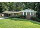 Charming home with a manicured lawn, attached carport, and lovely landscaping at 3390 Kenland Se Rd, Smyrna, GA 30082